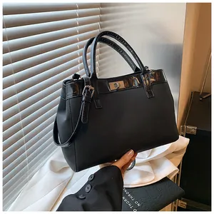 Minimalist black tote bag with silver buckle and adjustable strap for daily use