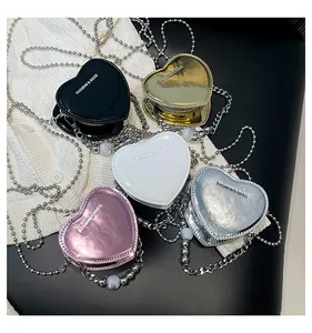 Mini heart-shaped crossbody bags set with metallic finish and beaded chain straps