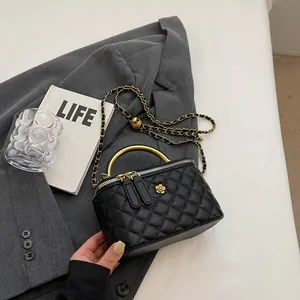 Quilted black crossbody bag with gold hardware and elegant chain strap on a white backdrop
