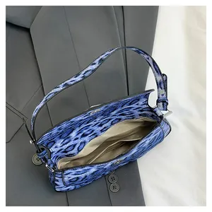 Vue détaillée du sac à bandoulière léopard montrant la doublure en tissu et le fermoir aimanté