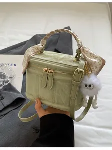 Retro light green box bag with ruched texture, heart scarf, and plush pendant detail