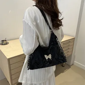 Water-ripple leather tote bag for women with silver butterfly detail and chain strap