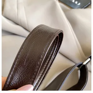 Close-up of dark brown lychee grain faux leather strap with detailed stitching and oil edge