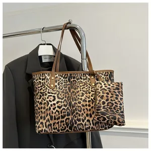 Detailed view of leopard print tote bag set with matching small pouch and gold studs