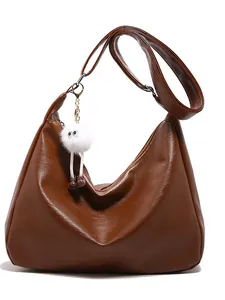 Brown leather hobo shoulder bag for women with cute white plush charm and adjustable strap