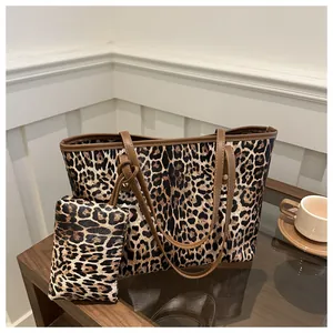 Leopard print tote bag set with matching small zipper pouch and brown leather straps