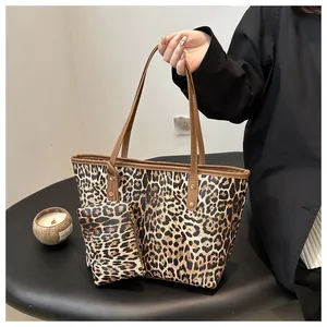Detailed view of leopard print tote bag with brown handles and matching pouch for women