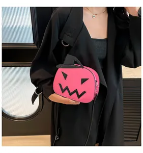 Close-up of pink pumpkin crossbody bag with black wizard hat and funny facial detail