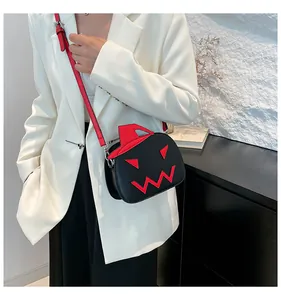 Detail of creative pumpkin-shaped crossbody bag with red wizard hat and shoulder strap