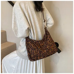 Detail of vintage leopard print hobo bag with gold chain and brown leather strap