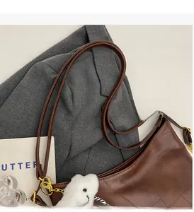 Close-up of woven texture on brown tote bag with cute plush bear keychain detail