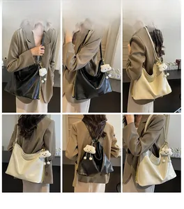 Detailed model views of a large chain tote bag in black and cream with cloud charm