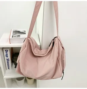Détails du sac bandoulière en nylon rose poudré avec fermetures éclair et sangle