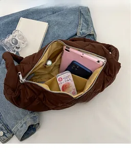 Interior view of large dark brown quilted bag showing spacious inner compartment and pockets