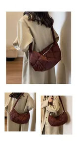Detailed view of dark brown quilted puffer hobo bag with zip closure and wide strap
