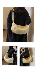 Detailed view of the quilted cream crescent bag with padded diamond stitching and zipper