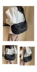 Detail of black quilted puffer bag showing large capacity and soft stitched diamond pattern