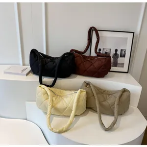 Detailed view of quilted puffer tote bags in black, coffee, yellow and beige colors