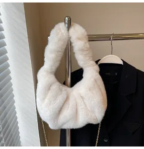 Détail du sac à main en peluche blanc crème avec poignée froncée et chaîne dorée