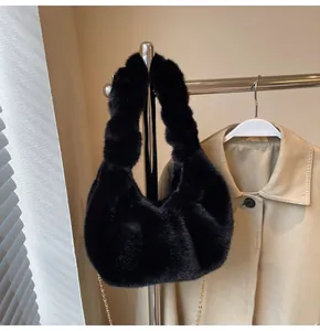 Détail du sac hobo en fausse fourrure noire avec texture douce et chaîne dorée chic