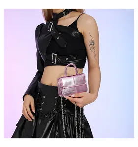 Macro view of purple metallic crocodile embossed mini bag with silver chain strap