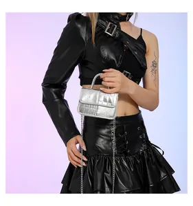 Detail of silver crocodile pattern mini handbag with metallic chain strap and top handle
