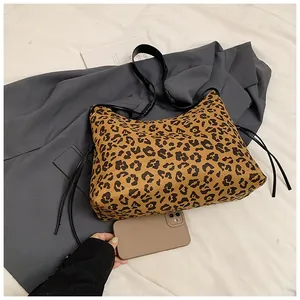 Top view of leopard print tote bag with black straps and side decorative ties