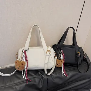 Retro lychee texture leather handbag for women in beige and black with bear charm