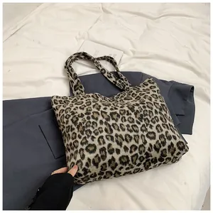 Detailed close-up of leopard print tote bag made of soft faux fur plush material