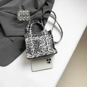 Grey leopard print mini tote bag with adjustable shoulder strap and compact design