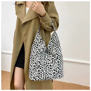 Close-up of leopard print tote bag styled with a beige trench coat for a chic daily look