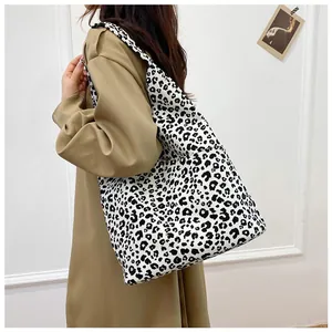 Leopard print canvas tote bag shown from side profile to emphasize large storage capacity