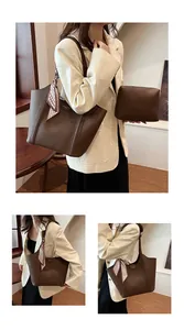 Detail der dunkelbraunen Leder-Tote mit Seidenschal am Griff und passender Tasche
