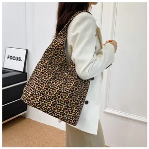 Detail shot of the metal magnetic buckle on this oversized leopard print canvas tote bag