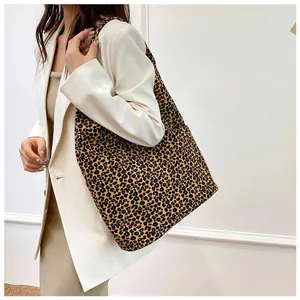 Fashionable leopard print canvas tote bag styled with a white blazer and beige dress