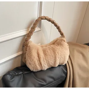 Detailed view of plush beige faux fur handbag featuring a woven PU leather shoulder handle