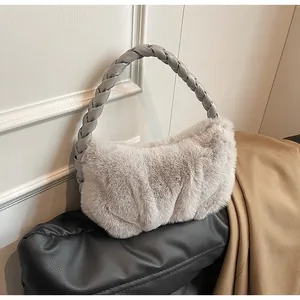 Detail of the gray plush handbag featuring a braided leather handle and soft faux fur texture