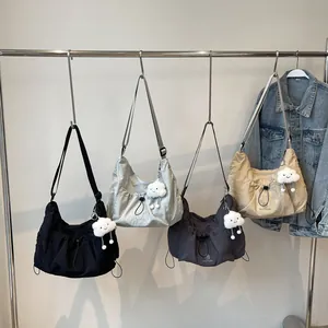 Large nylon crescent crossbody bag in four colors with cute cloud pendants and straps