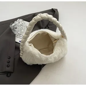 Detail view of cream plush faux fur handbag with braided handle and golden zipper