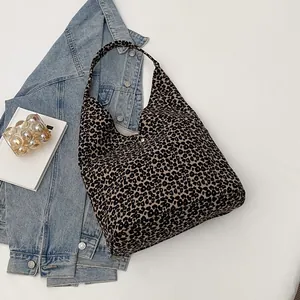 Chic leopard print canvas tote bag with a retro crescent shape and wide shoulder strap