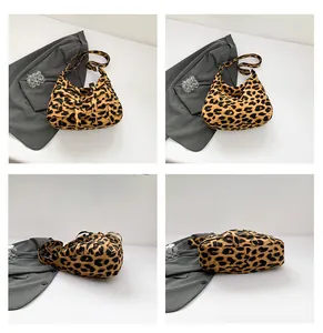 Detail view of leopard print tote bag with woven texture and reinforced shoulder strap