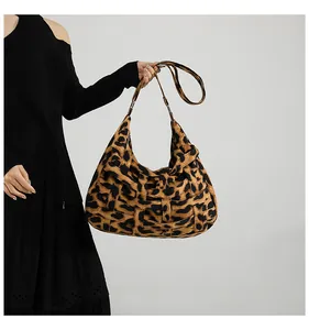 Detail of the oversized leopard print woven tote bag showing texture and handle design