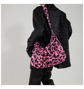 Macro detail of pink leopard print woven texture and fabric on a large tote bag