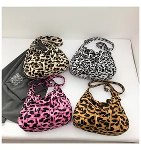 Flat lay view showing four vibrant leopard print woven tote bags in various color schemes
