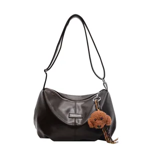 Stylish dark brown underarm bag with pleated hobo design and a cute teddy bear charm