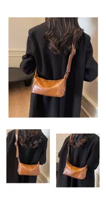 Detailed view of brown retro underarm bag with smooth faux leather texture and strap