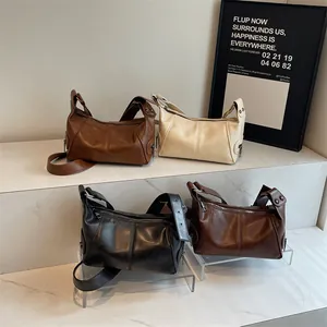 Vintage faux leather underarm bags in brown, beige, and black with rivet wide straps