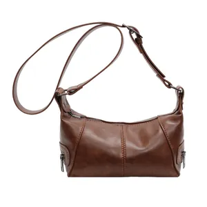 Vintage brown PU leather underarm bag with decorative zippers and adjustable strap