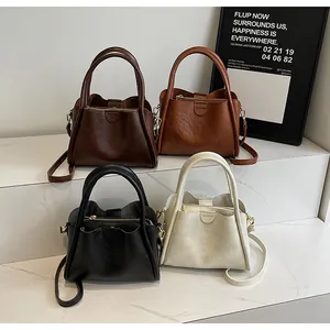 Detail view of vintage PU leather handbags in four colors with textured finish