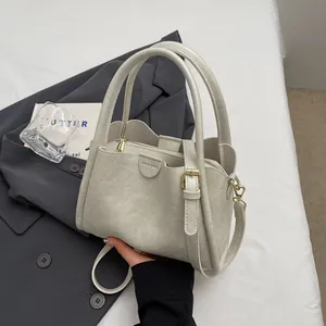 Vintage light gray leather crossbody bag with top handles and adjustable strap